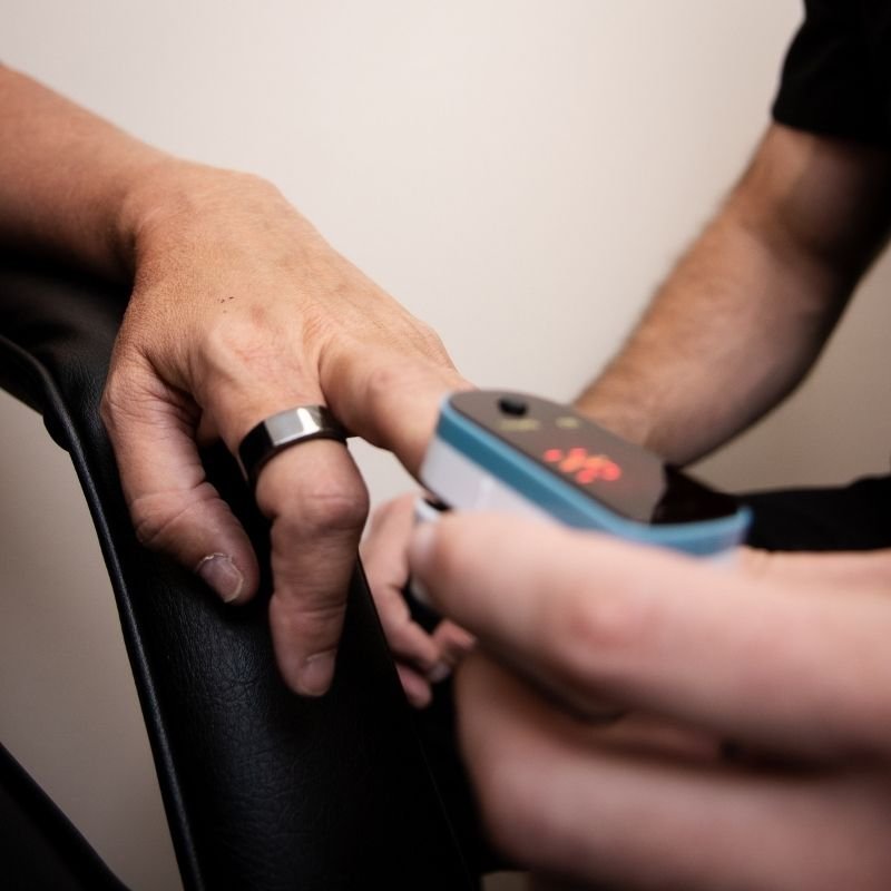 Physician measuring patient health markers as part of medical weight loss and hormone support program at Ignite Performance and Health in Chesterfield, MO.