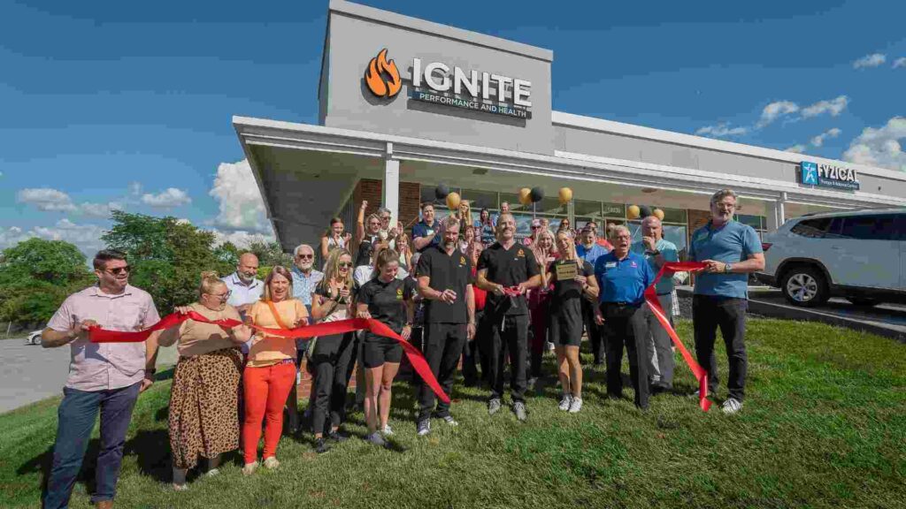 Ignite Performance and Health team and community members gathered outside the facility for a ribbon-cutting celebration.
