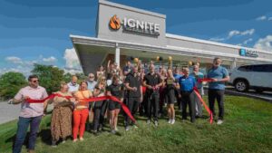 Ignite Performance and Health team and community members gathered outside the facility for a ribbon-cutting celebration.