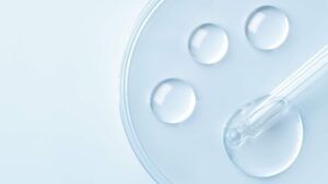 Clear serum drops and a glass dropper representing hormone therapy and peptide treatment options.