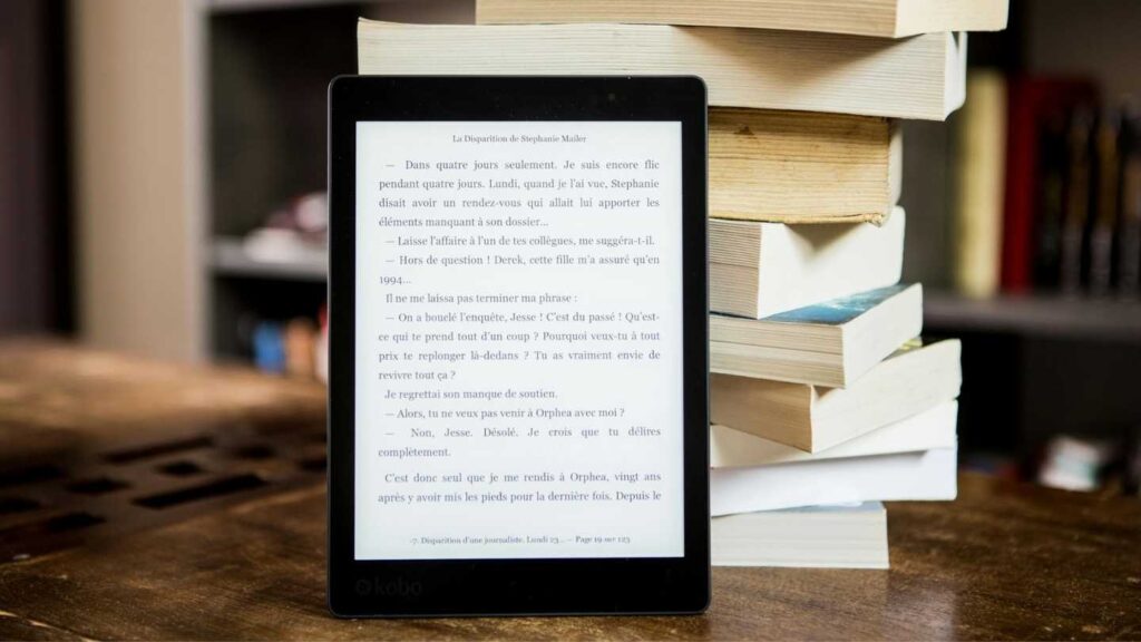 E-reader beside a stack of books representing Ignite health and performance ebooks.
