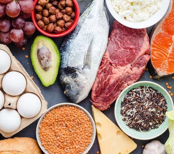 Protein-rich foods, vegetables, fruit, whole grains, and healthy fats representing personalized nutrition coaching.