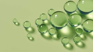 Abstract green droplets representing peptide therapy, cellular health, and medical wellness.